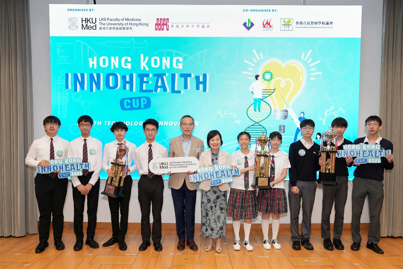 The award-winning teams pose for a photo with Dr Choi Yuk-lin, Secretary for Education (right sixth); Professor Chak-sing Lau, Vice-President & Pro-Vice-Chancellor (Health) and Dean of Medicine of HKU (left fifth).