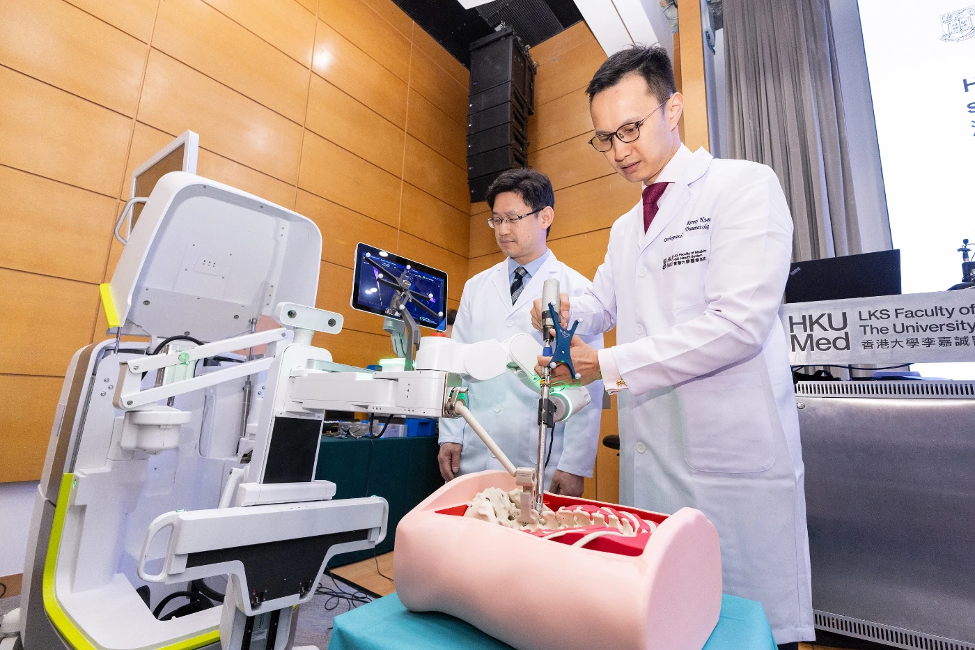 Dr Kenny Kwan Yat-hong (right) demonstrates the robot-assisted spine surgery.