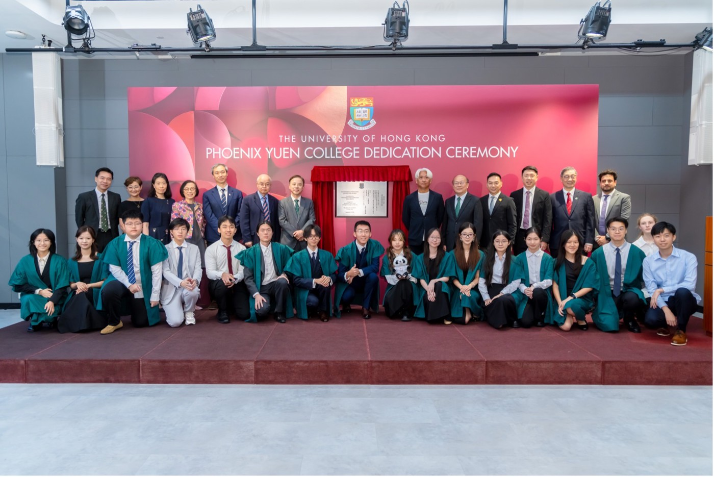 Guests and students pose with the dedication plaque.