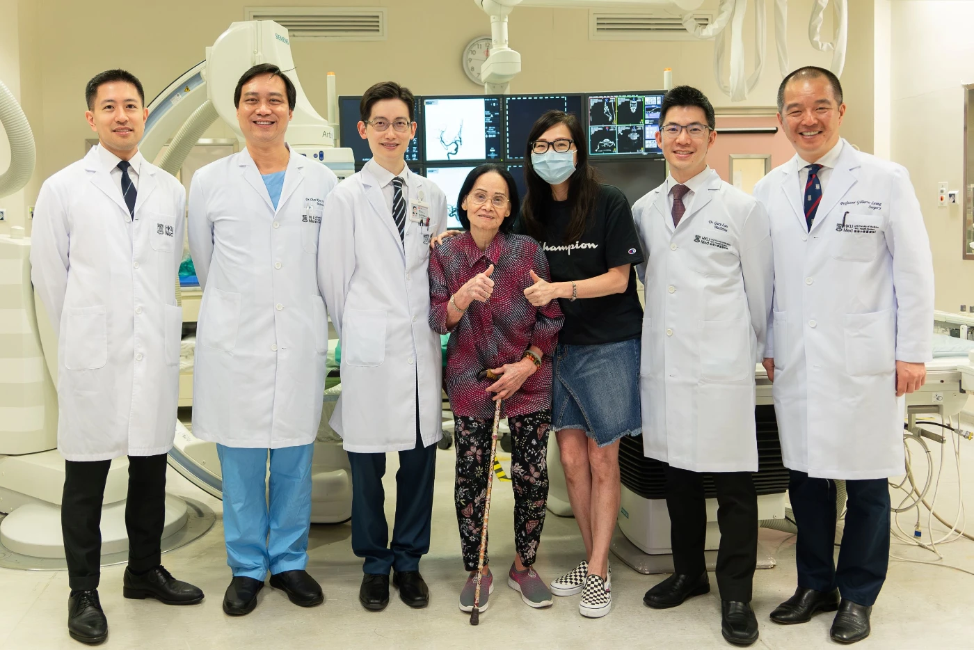 The 84-year-old stroke survivor, Ms Lau, shares that she can quickly return to independent living after the surgery. (From left) Dr Edward Chu Yin-lun, Dr Chan Koon-ho, Dr Kevin Cheng King-fai, stroke survivor Ms Lau and her daughter, Dr Gary Lau Kui-kai and Professor Gilberto Leung Ka-kit.