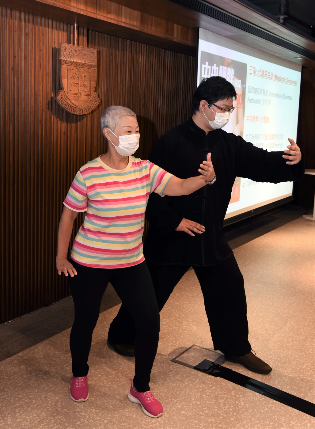 Ms Rebecca Chan and Mr Angus Yu make a Tai Chi pose. Mr Yu serves as a Tai Chi master in the study.