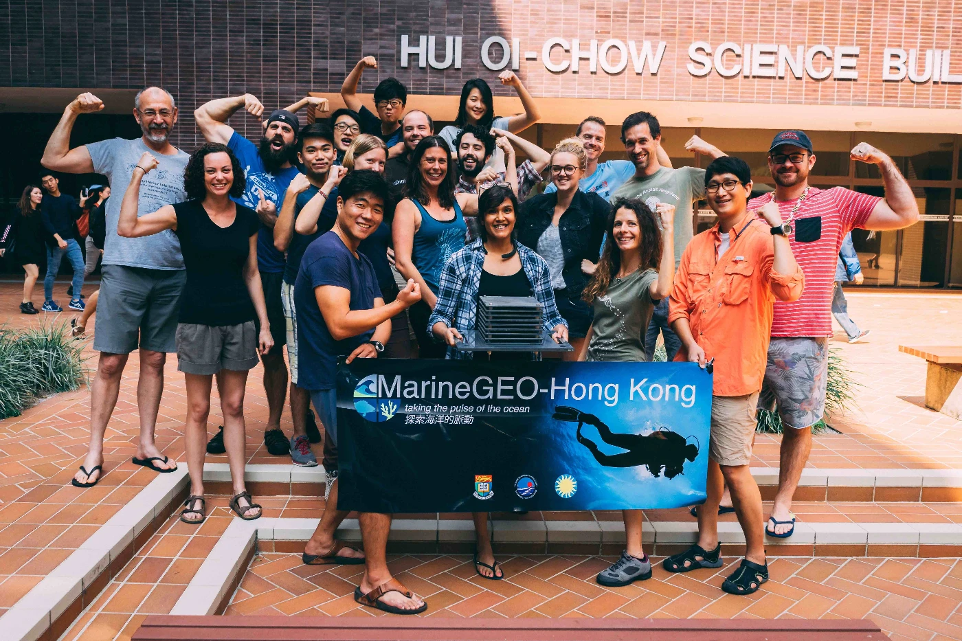 A group of local and international scientific collaborators take a break from the day’s work to flex their ARMS muscle.