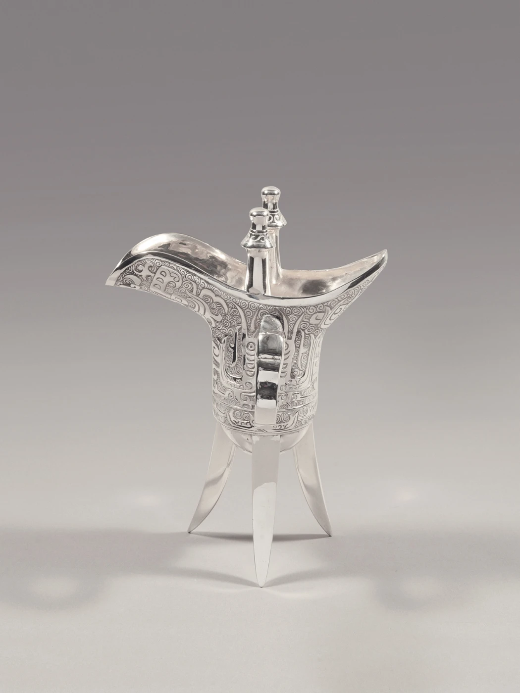 Jue–shaped cup 
Cast, chased and polished sterling silver
Hong Kong, Wai Kee Jewellers Ltd., 1980s
Stamped with Wai Kee trademark and collector’s mark
Loan from the Estate of Kwan Sai Tak