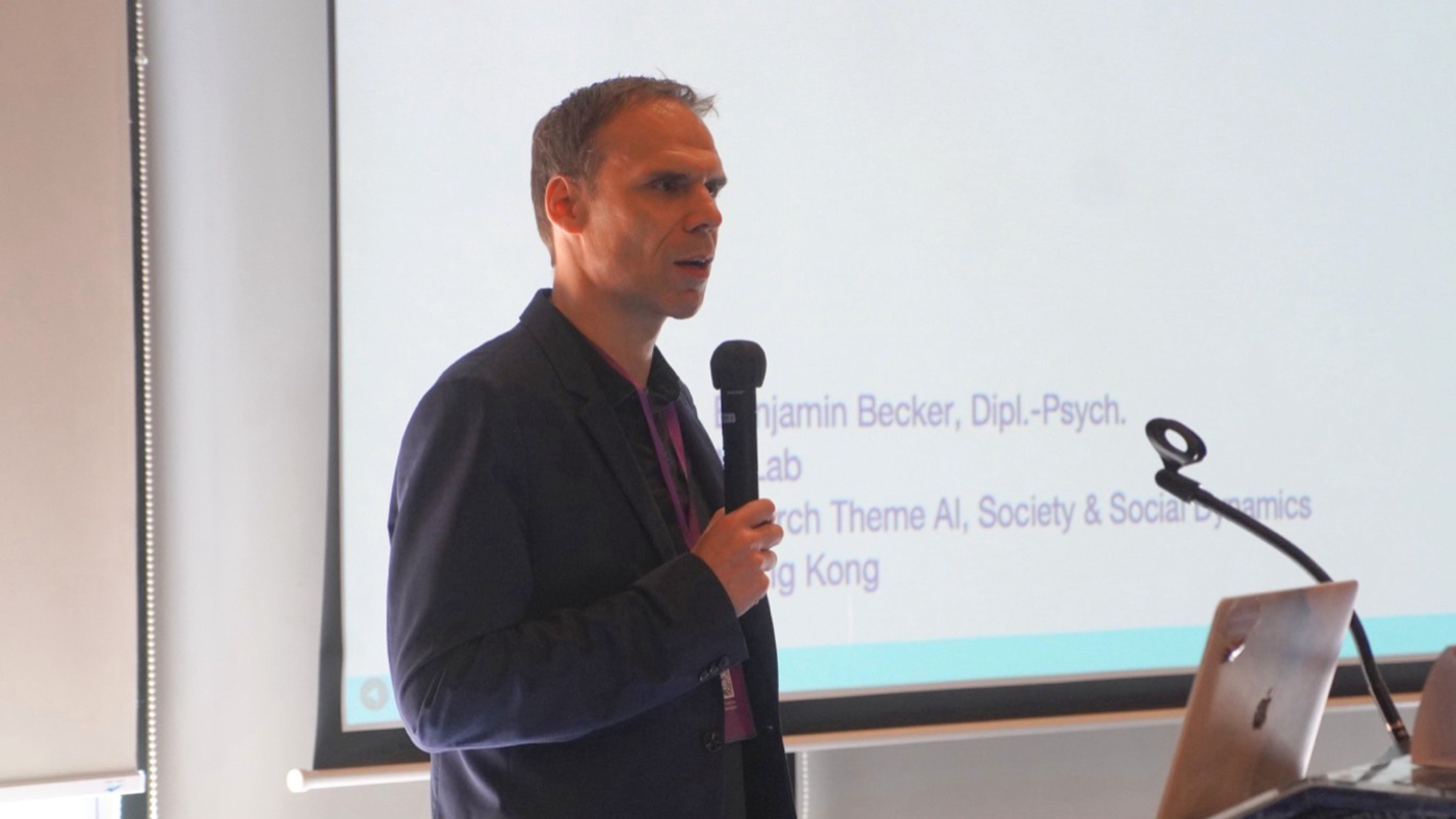 Professor Benjamin Becker gives a talk at the AI & Humans conference in Bali, Indonesia.