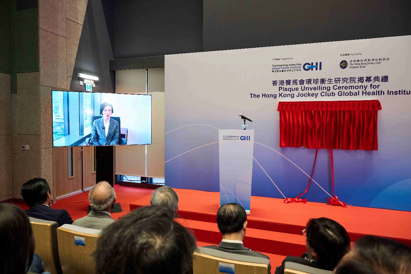Dr Cecilia Fan, Acting Secretary for Health of the Government of the HKSAR, delivers a speech by video at the plaque- unveiling ceremony of the HKJCGHI.