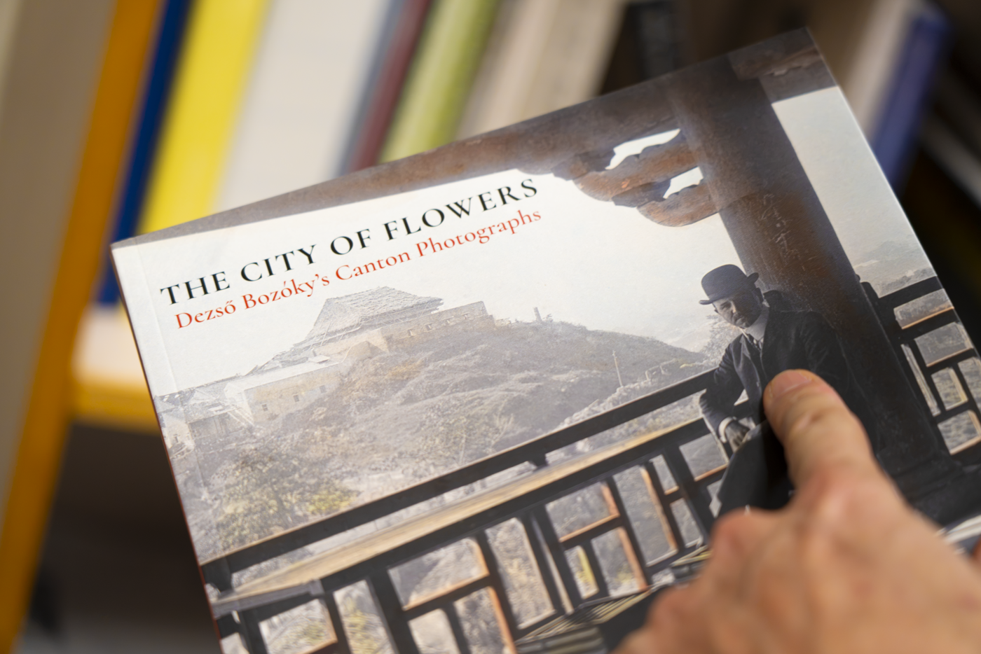 Professor Knothe holding a book of photographs from Old Canton.