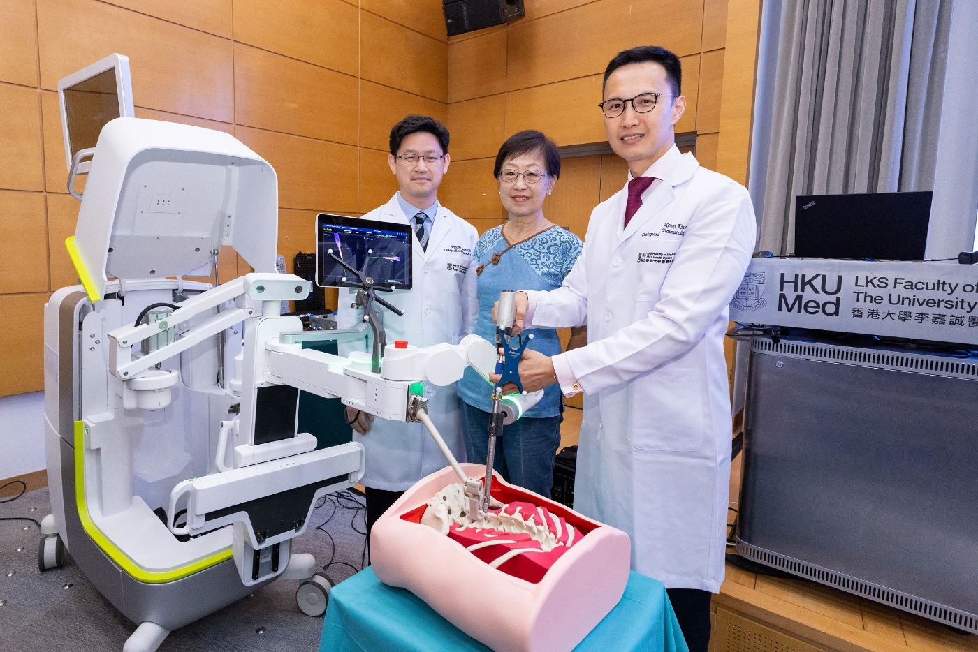 The use of robotic technology in spine surgery provides unprecedented precision. (From left) Professor Jason Cheung Pui-yin, Ms Lau who underwent robot-assisted spine surgery in October 2023, and Dr Kenny Kwan Yat-hong.