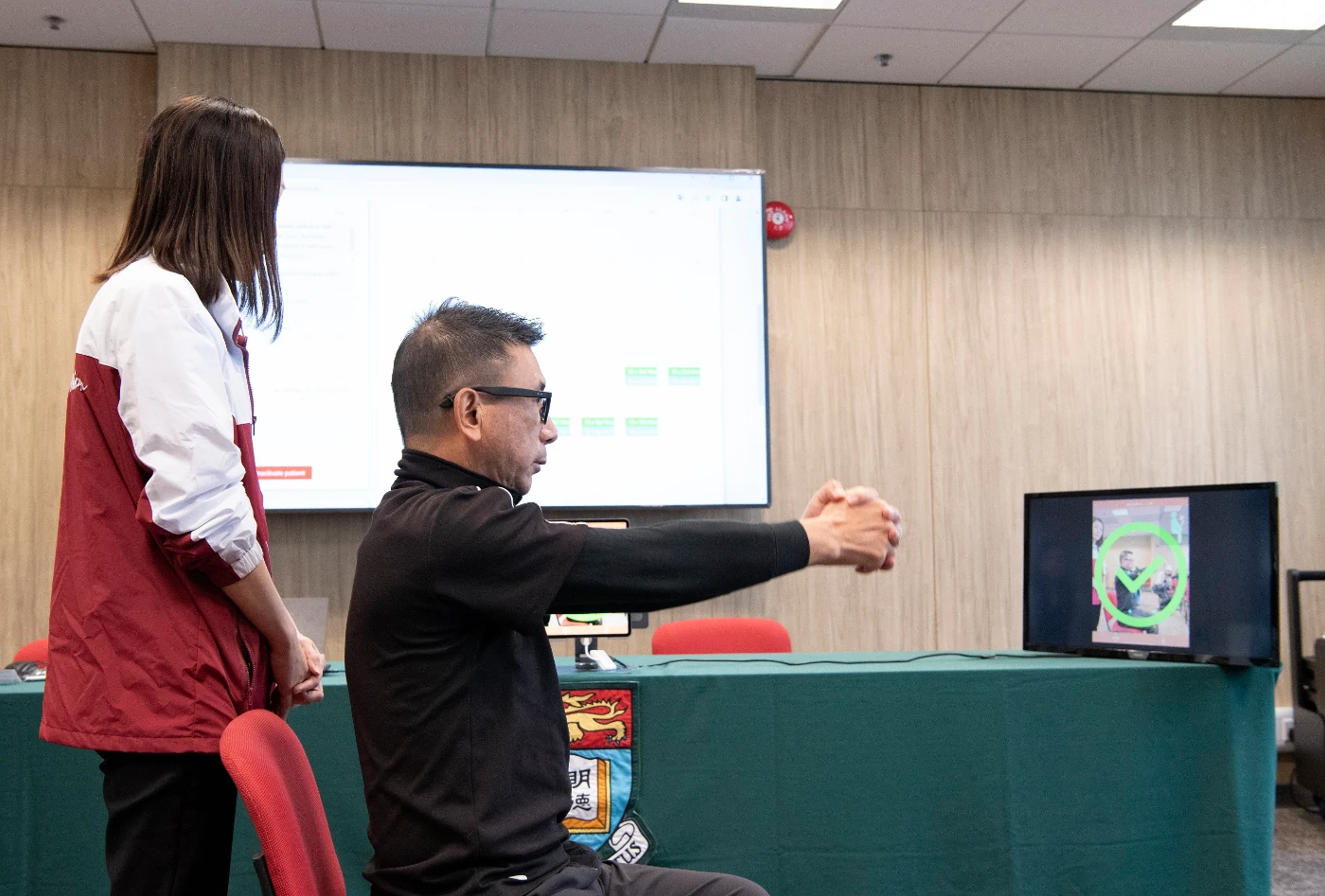 The stroke patient Mr Tam is demonstrating the use of SmartRehab platform.