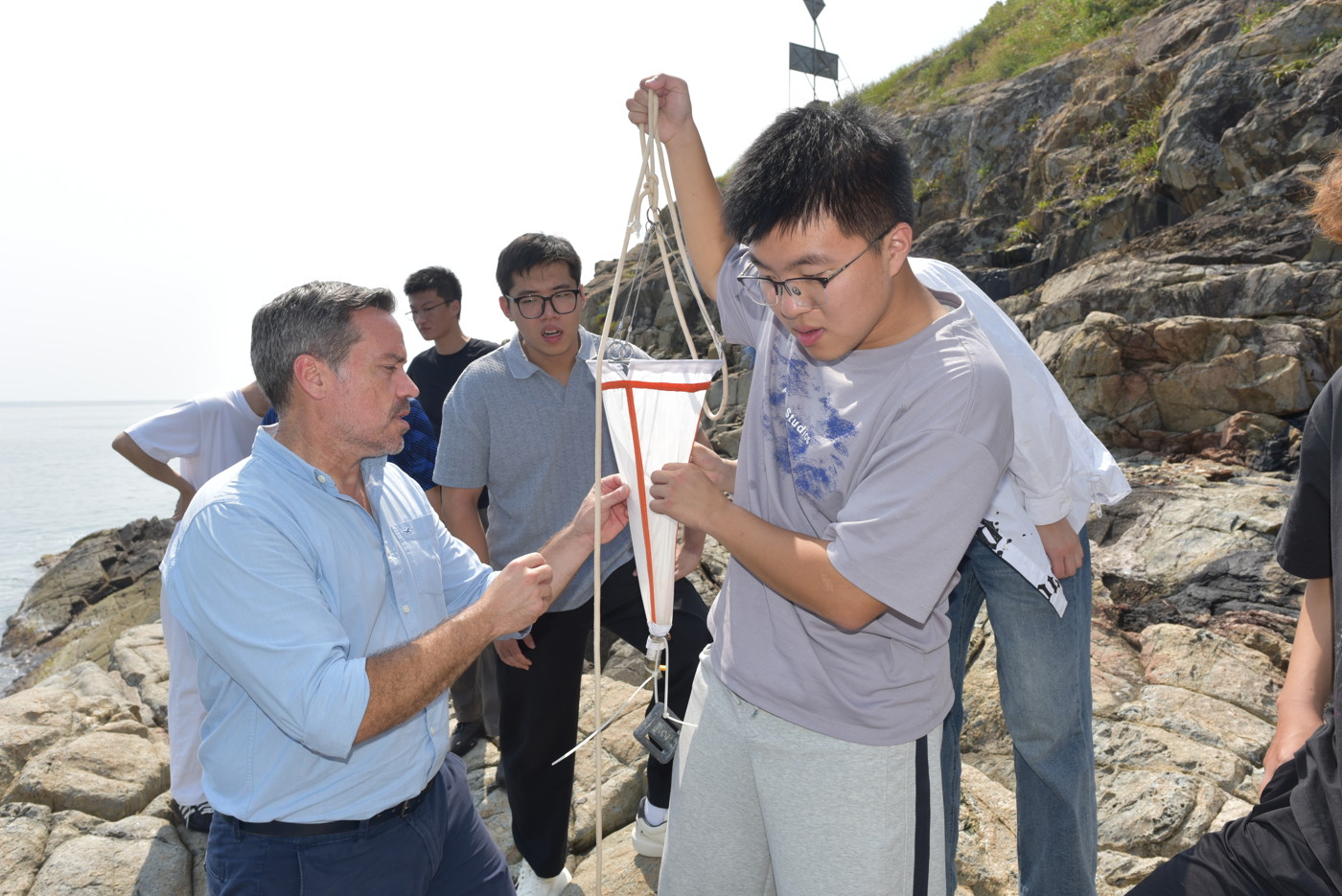 Dr. Not teaching IMEC students how to take samples using a plankton net. Image: The Swire Institute of Marine Science